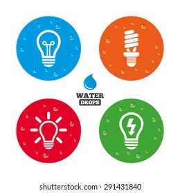 Water drops on button. Light lamp icons. Fluorescent lamp bulb symbols. Energy saving. Idea and success sign. Realistic pure raindrops on circles. Vector
