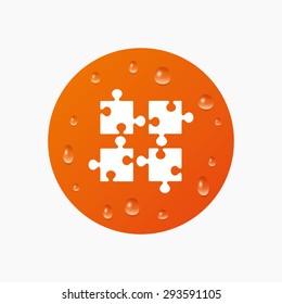 Water drops on button. Puzzles pieces sign icon. Strategy symbol. Ingenuity test game. Realistic pure raindrops. Orange circle. Vector