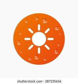 Water drops on button. Sun sign icon. Solarium symbol. Heat button. Realistic pure raindrops. Orange circle. Vector