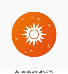 Water drops on button. Sun sign icon. Solarium symbol. Heat button. Realistic pure raindrops. Orange circle. Vector