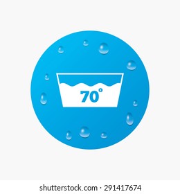 Water drops on button. Wash icon. Machine washable at 70 degrees symbol. Realistic pure raindrops. Blue circle. Vector