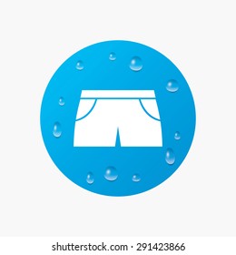 Water drops on button. Women's sport shorts sign icon. Clothing symbol. Realistic pure raindrops. Blue circle. Vector