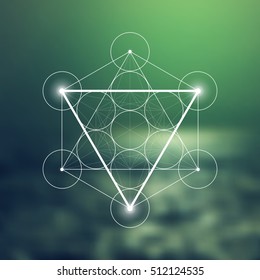 Water element symbol inside Metatron Cube and Flower of Life in front of natural blurry background. Sacred geometry futuristic vector design.