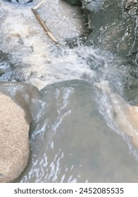 water flowing over small river rocks