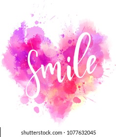 Watercolor imitation heart shaped pink background with "Smile" handwritten modern calligraphy message. Inspirational text.