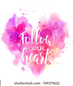 Watercolor imitation heart shaped pink background with "Follow your heart" handwritten modern calligraphy message. Vector illustration