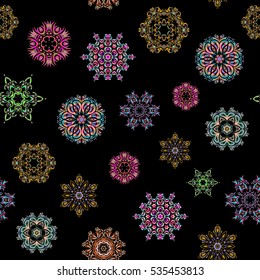 Watercolor painting effect. Seamless pattern with snowflakes, doodles and dots in blue, pink and neutral colors on black background. For the Christmas design and decoration. Handmade drawing.