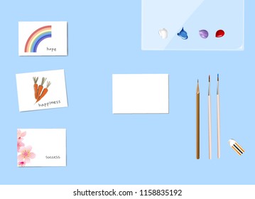 Watercolor paintings cards, Empty card, paint brush, Palette and pencils on blue background.