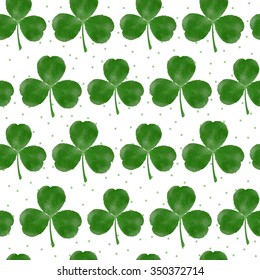 Watercolor three-leaf clover shamrock seamless background
