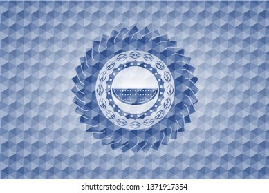 watermelon icon inside blue emblem or badge with abstract geometric pattern background.