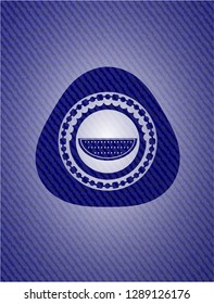 watermelon icon inside emblem with jean background