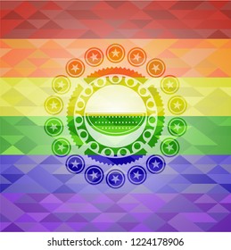 watermelon icon inside emblem on mosaic background with the colors of the LGBT flag