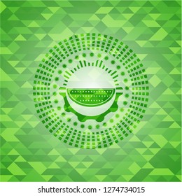 watermelon icon inside green emblem with mosaic background