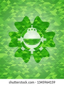 watermelon icon inside green emblem with mosaic background