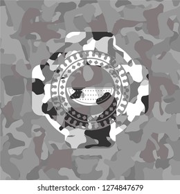 watermelon icon inside grey camo emblem