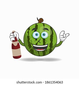 Watermelon mascot character holding a bottle. vector illustration