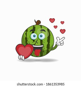 Watermelon mascot character holding a love icon. vector illustration