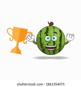 Watermelon mascot character with a trophy in right hand. vector illustration