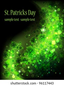 Wave of magic sparkling clover on a black background.  St. Patrick's Day abstract background