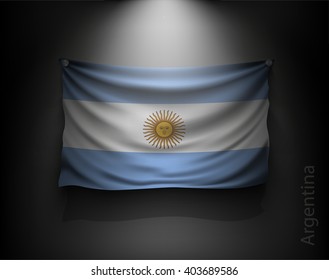 waving flag Argentina  on a dark wall with a spotlight, illuminated