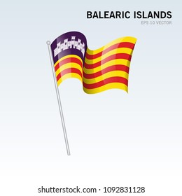 Waving flag of Balearic Islands the autonomous communities of Spain on gray background