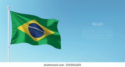 Waving flag of Brazil on a pole with a blue sky backdrop with copyspace