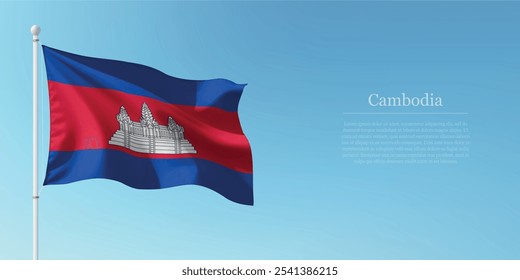 Waving flag of Cambodia on a pole with a blue sky backdrop with copyspace