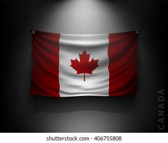 waving flag canada on a dark wall with a spotlight, illuminated