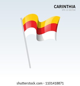 Waving flag of Carinthia state of Austria on gray background