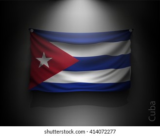 waving flag cuba on a dark wall with a spotlight, illuminated