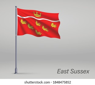 Waving flag of East Sussex - county of England on flagpole. Template for independence day