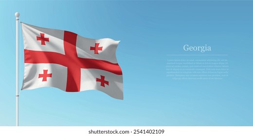Waving flag of Georgia on a pole with a blue sky backdrop with copyspace