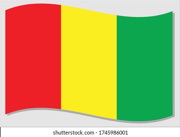 Waving flag of Guinea vector graphic. Waving Guinean flag illustration. Guinea country flag wavin in the wind is a symbol of freedom and independence.