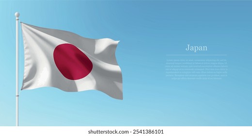 Waving flag of Japan on a pole with a blue sky backdrop with copyspace