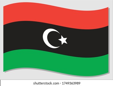 Waving flag of Libya vector graphic. Waving Libyan flag illustration. Libya country flag wavin in the wind is a symbol of freedom and independence.