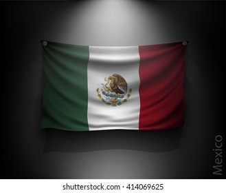 waving flag mexico on a dark wall with a spotlight, illuminated