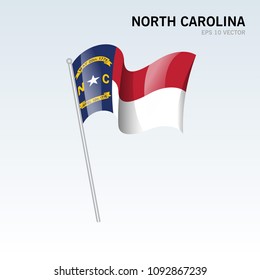 Waving flag of North Carolina state of United States of America on gray background