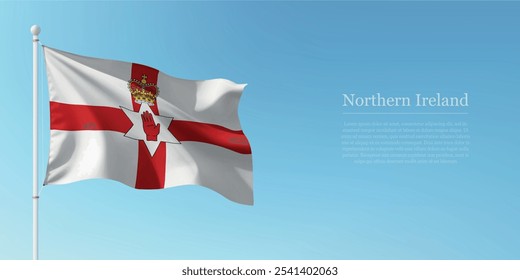 Waving flag of Northern Ireland on a pole with a blue sky backdrop with copyspace