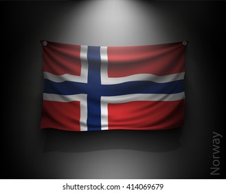 waving flag norway on a dark wall with a spotlight, illuminated