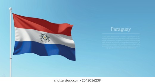 Waving flag of Paraguay on a pole with a blue sky backdrop with copyspace