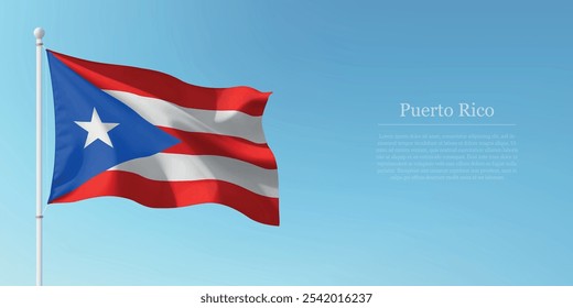 Waving flag of Puerto Rico on a pole with a blue sky backdrop with copyspace