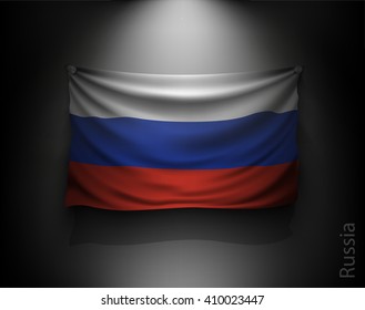 waving flag russia on a dark wall with a spotlight, illuminated
