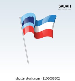 Waving flag of Sabah state and federal territory of Malaysia isolated on gray background