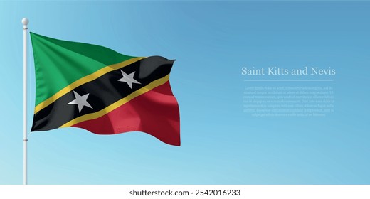Waving flag of Saint Kitts and Nevis on a pole with a blue sky backdrop with copyspace