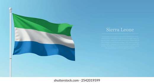 Waving flag of Sierra Leone on a pole with a blue sky backdrop with copyspace