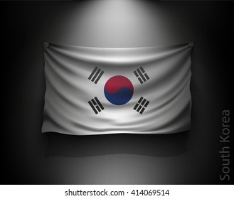 waving flag South Korea on a dark wall with a spotlight, illuminated
