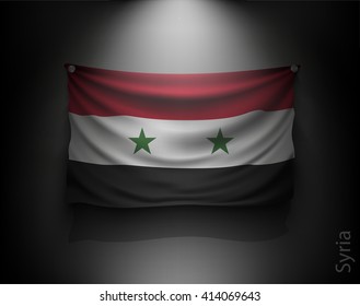 waving flag syria on a dark wall with a spotlight, illuminated