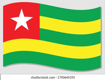 Waving flag of Togo vector graphic. Waving Togolese flag illustration. Togo country flag wavin in the wind is a symbol of freedom and independence.