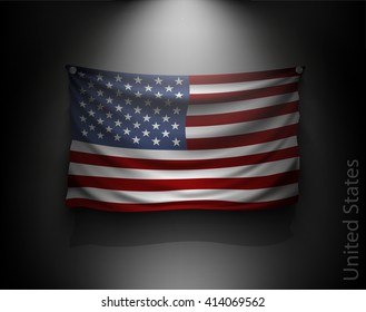 waving flag United States on a dark wall with a spotlight, illuminated