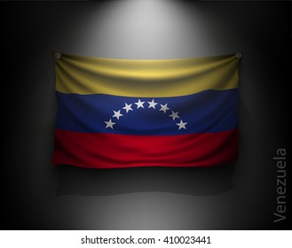 waving flag venezuela  on a dark wall with a spotlight, illuminated